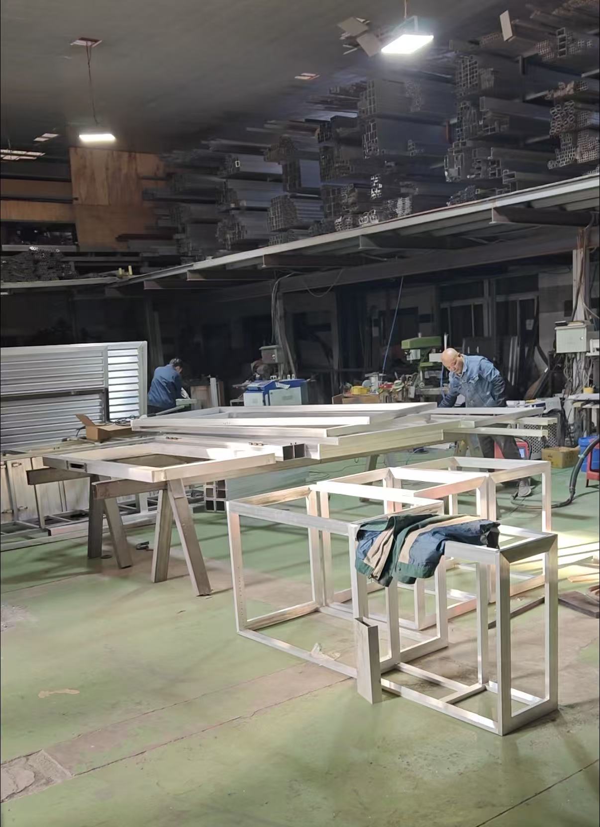 Workers preparing aluminium frames in the Bluehour workshop